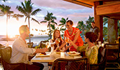 At an outdoor restaurant, a Cast Member serves a food platter to 3 Guests toasting with wine
At an outdoor restaurant, a Cast Member serves a food platter to 3 Guests toasting with wine
