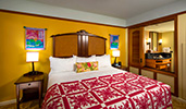 A king bed with 2 night stands near a shuttered privacy partition
A king bed with 2 night stands near a shuttered privacy partition