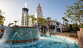 A fountain near trees and a building with a marque A fountain near trees and a building with a marque