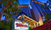 A sign says Disneys Paradise Pier Hotel, with the hotel standing tall behind the sign
A sign says Disneys Paradise Pier Hotel, with the hotel standing tall behind the sign