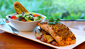 A plate with a salmon filet, red potatoes and a salad with garlic bread
A plate with a salmon filet, red potatoes and a salad with garlic bread