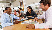 Business colleagues work together in small group at tables in a casual meeting area
Business colleagues work together in small group at tables in a casual meeting area