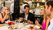 Four Guests eat and drink in a cozy restaurant with an open kitchen
Four Guests eat and drink in a cozy restaurant with an open kitchen