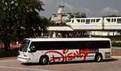 A Disney Transport shuttle is parked near a monorail track
A Disney Transport shuttle is parked near a monorail track