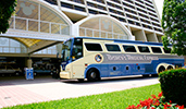 Disneys Magical Express motorcoach in front of a Disney Resort hotel Disneys Magical Express motorcoach in front of a Disney Resort hotel