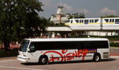 A Disney motorcoach in front of the monorail by the Main Entrance of Magic Kingdom park A Disney motorcoach in front of the monorail by the Main Entrance of Magic Kingdom park