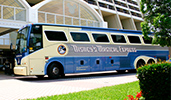 A Disney's Magical Express bus waits in front of a hotel entrance
A Disney's Magical Express bus waits in front of a hotel entrance