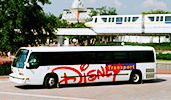 A Disney Transport shuttle is parked near a monorail track
A Disney Transport shuttle is parked near a monorail track