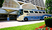 Disneys Magical Express motorcoach near a building Disneys Magical Express motorcoach near a building