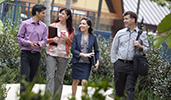 People wearing business attire walking in an outdoor environment People wearing business attire walking in an outdoor environment