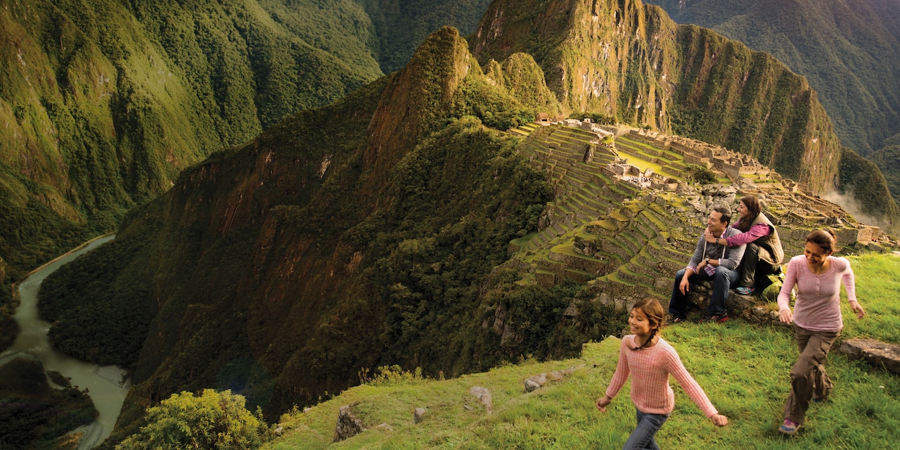 A family of 4 visits the ancient Incan ruins of Machu Picchu in Peru

