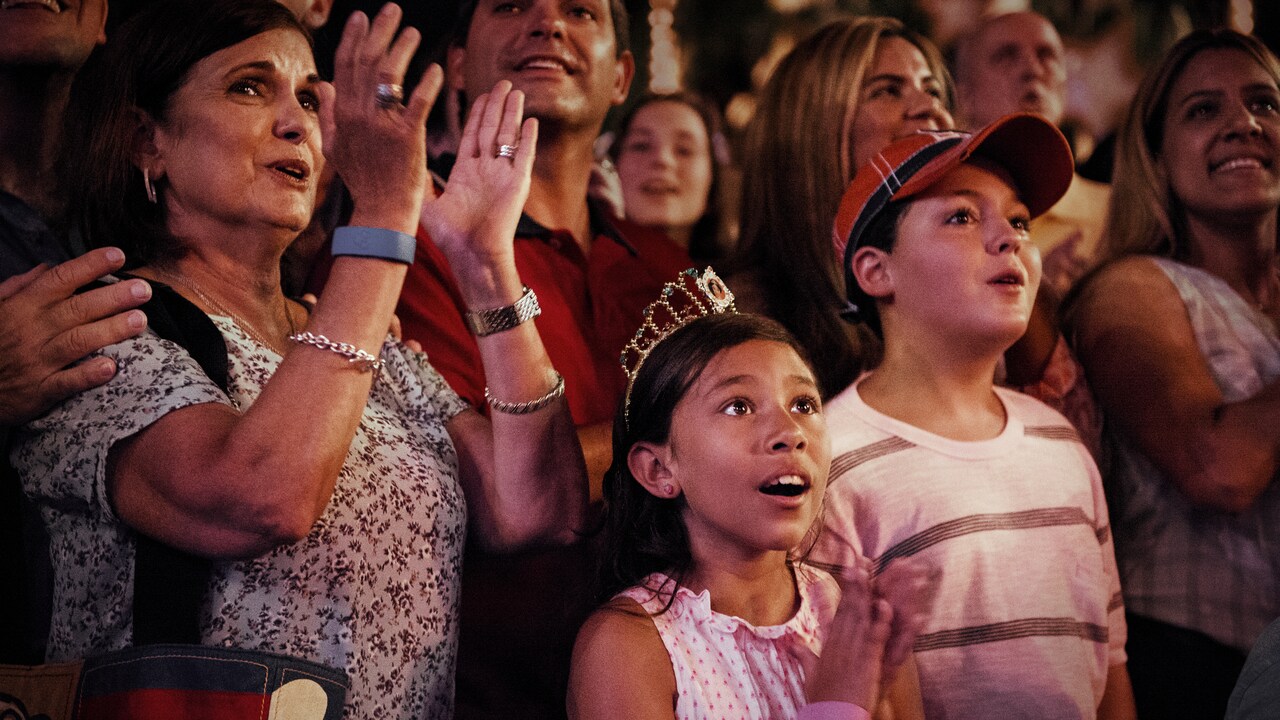 Several people looking up in awe while applauding