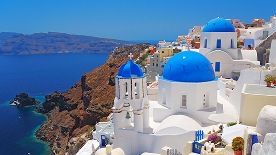 The blue domes of Santorini, Greece along the Mediterranean Sea