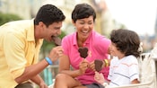 Earn a $200 statement credit with the Disney Premier Visa® Card A mother and father enjoy Mickey Ice Cream Bars with their son