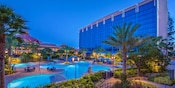 A nighttime view of the Disneyland Hotel pools with the Fantasy Tower in the background A nighttime view of the Disneyland Hotel pools with the Fantasy Tower in the background