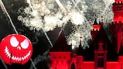 The Halloween Screams fireworks go off behind Sleeping Beauty Castle and a Jack Skellington decoration