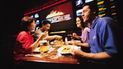 Friends take a break from the ESPN Zone Sports Arena games for food from the ESPN Zone restaurant
