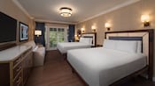 A room with 2 beds, drawers, a couch, a TV, a painting, lamps, a mirror, curtains and balcony access