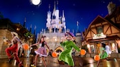 Children dressed as a scarecrow, Minnie Mouse and Tinker Bell march along with Dopey at Mickey's Not-So-Scary Halloween Party