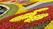 Bright flowers form a Mickey Mouse design in a garden at Epcot International Flower & Garden Festival