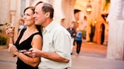A mature couple enjoying a glass of wine and hors d'oeuvres