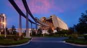 The monorail entering the main concourse of Disney's Contemporary Resort at sunset