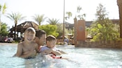 A father enjoys pool time with his two young boys A father enjoys pool time with his two young boys