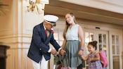 A mother and daughter are greeted by a Cast Member in the lobby of their Disney Resort hotel A mother and daughter are greeted by a Cast Member in the lobby of their Disney Resort hotel