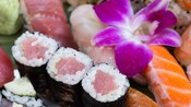 Tempting selection of fresh sushi garnished with an orchid flower