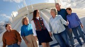 A tour guide leads her group to Space Mountain in Disneyland Park