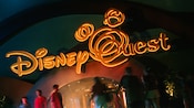 Disney Quest sign lit up at night