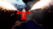 Fireworks shoot from the hands of Sorcerer Mickey Mouse in Fantasmic!