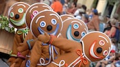 Dancing Gingerbread men lead their float through Disney Parks Christmas Day Parade