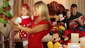 A happy family celebrating the holiday season together inside their Disney Resort hotel room