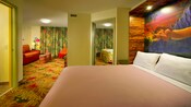 A Murphy-style bed with a picture of Simba above it and, in the background, a bedroom and a living room