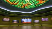 Colorful canvas prints and an oversized illuminated jungle-themed light fixture inside Landscape of Flavors