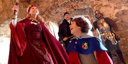 A mother and son get dressed up in historic costumes as they explore a castle