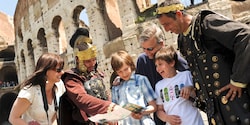 Tourists consult a map with men dressed in emperor and soldier costumes near the Roman Colosseum