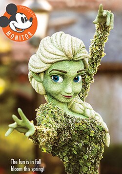 Un arbusto artístico en forma de Elsa con el mensaje “The fun is in full bloom this spring” superimpuesto