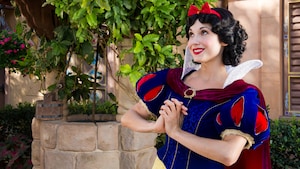 Snow White smiles while awaiting Guests at a Character Greeting experience at the Germany Pavilion