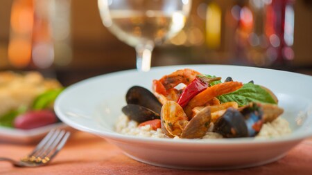 Dining area with private tables and a long table in the center of the room with family-style seating