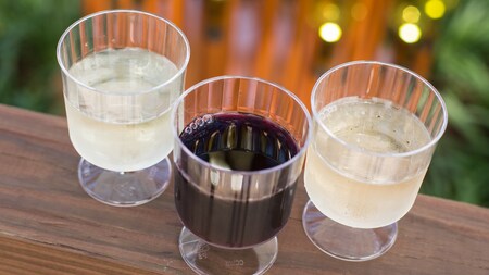 3 plastic glasses containing wine samples