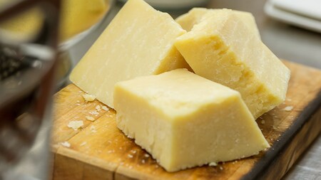 3 blocks of dry aged cheese on a cutting board