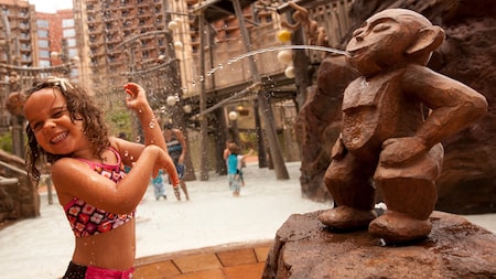 A father and son playing in the beach lagoon at Aulani Resort