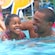 A father and daughter enjoy time in the pool at their Disney Resort hotel