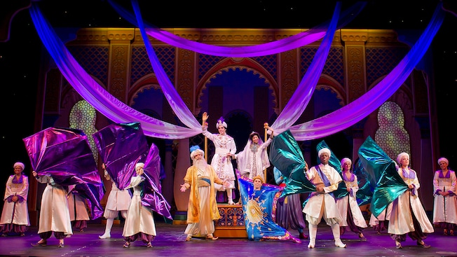 Aladdin, Jasmine, the Sultan and Magic Carpet are joined by an ensemble of palace guards waving fabric
