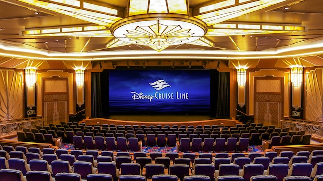 A spacious theater with a large stage and a high curtain