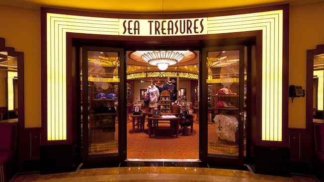 A lit art deco sign identifies Sea Treasures, a store