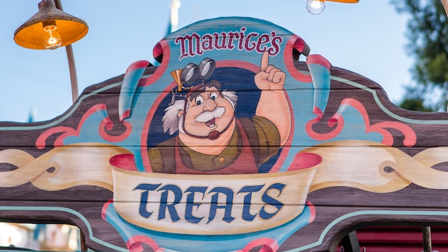 A colorful wooden sign at Fantasy Faire reads, ‘Maurice’s Treats’