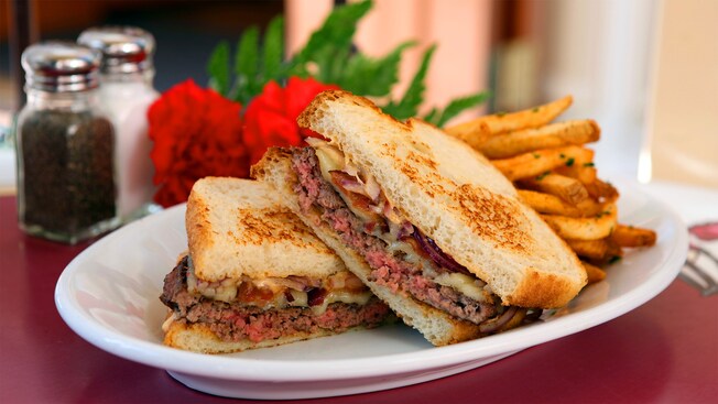 A plated serving of the sourdough bacon cheese melt with French fries from Carnation Cafe